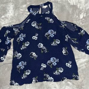 Off the shoulder blue flowered blouse.
